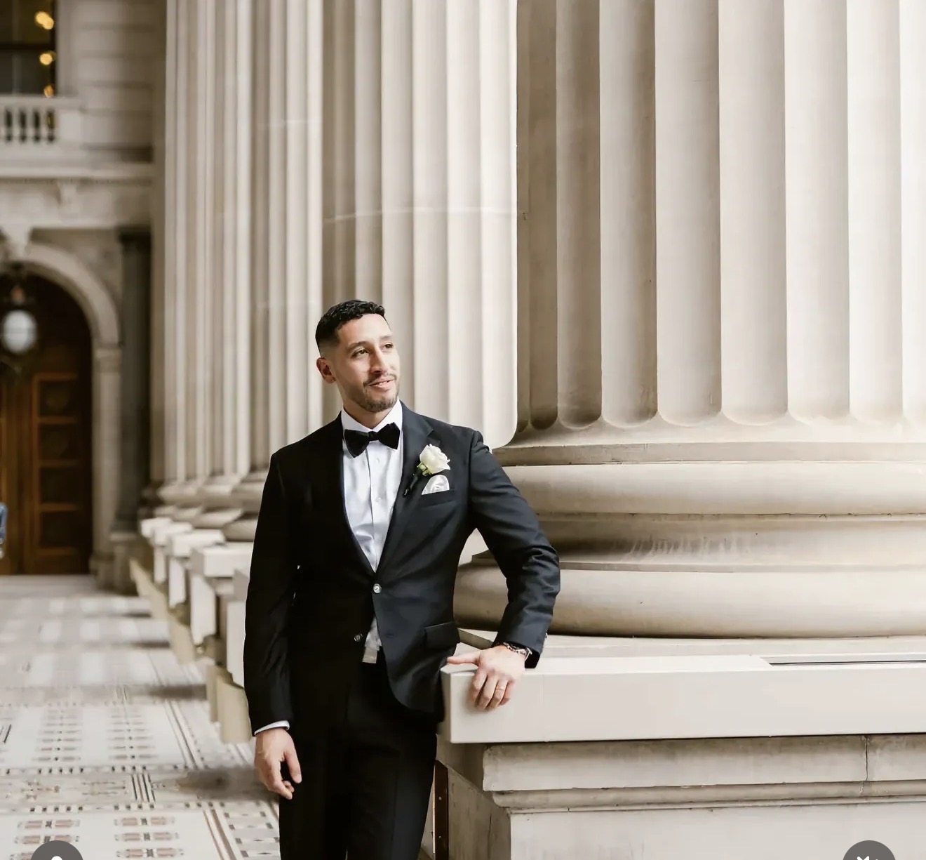 Groom in a black tuxedo with a styled haircut