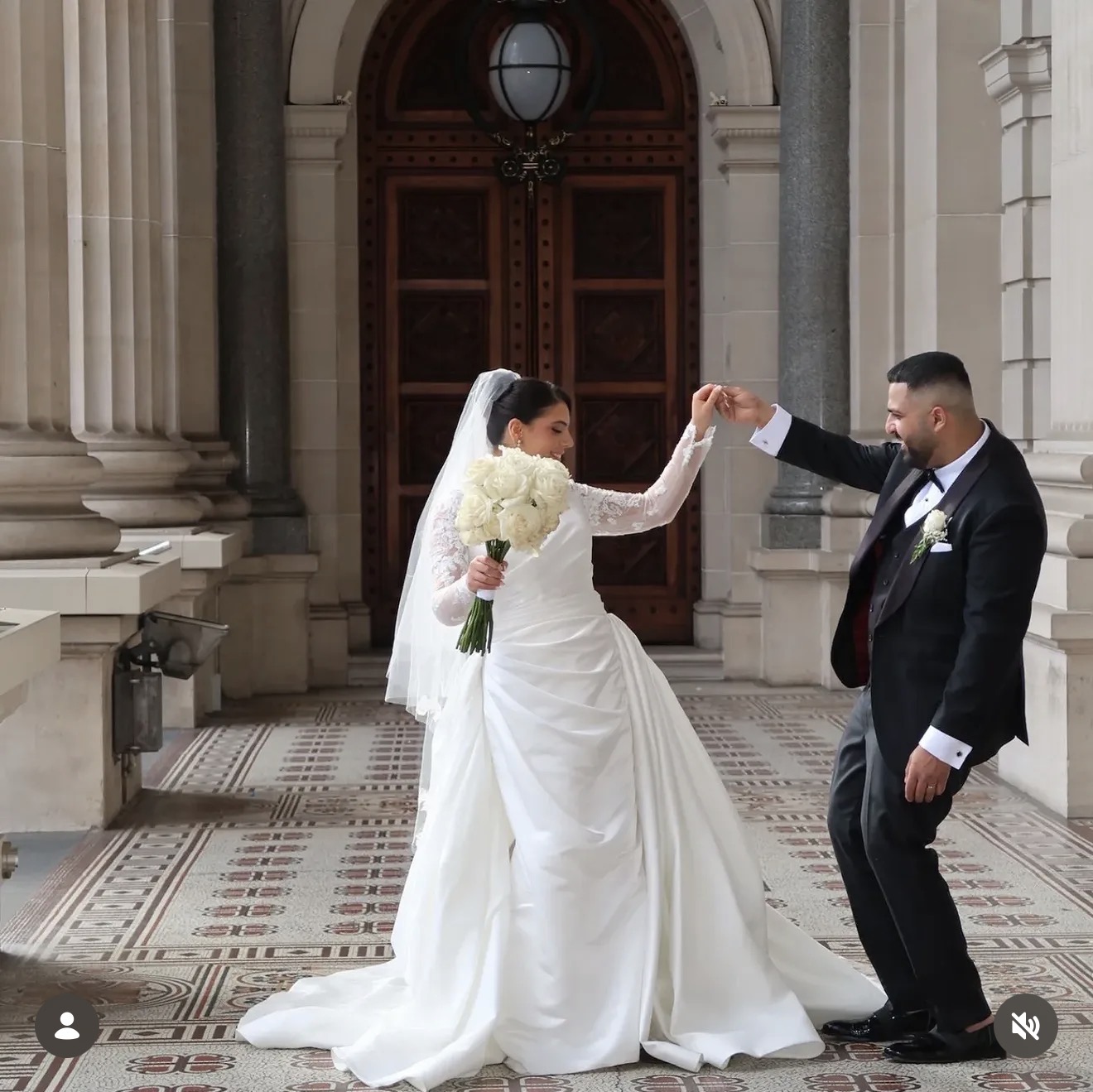 Bride and groom facing each other and holding hands